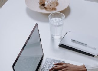 How to earn money by writing and blogging about cryptocurrency projects? person in white long sleeve shirt using macbook pro