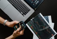 What is Cryptocurrency Trading? hands holding a smartphone with data on screen