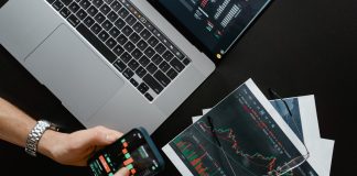 What is Cryptocurrency Trading? hands holding a smartphone with data on screen