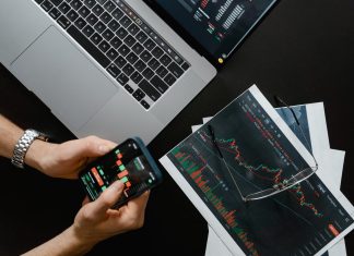What is Cryptocurrency Trading? hands holding a smartphone with data on screen