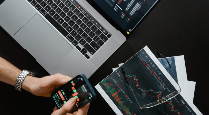 What is Cryptocurrency Trading? hands holding a smartphone with data on screen