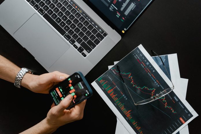 pexels-photo-7567443 hands holding a smartphone with data on screen