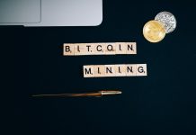 What is Cryptocurrency mining? a bitcoin and pen on a black surface
