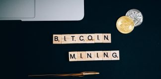 What is Cryptocurrency mining? a bitcoin and pen on a black surface