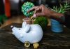 What are Cryptocurrency Airdops? a person putting bitcoin in a piggy bank